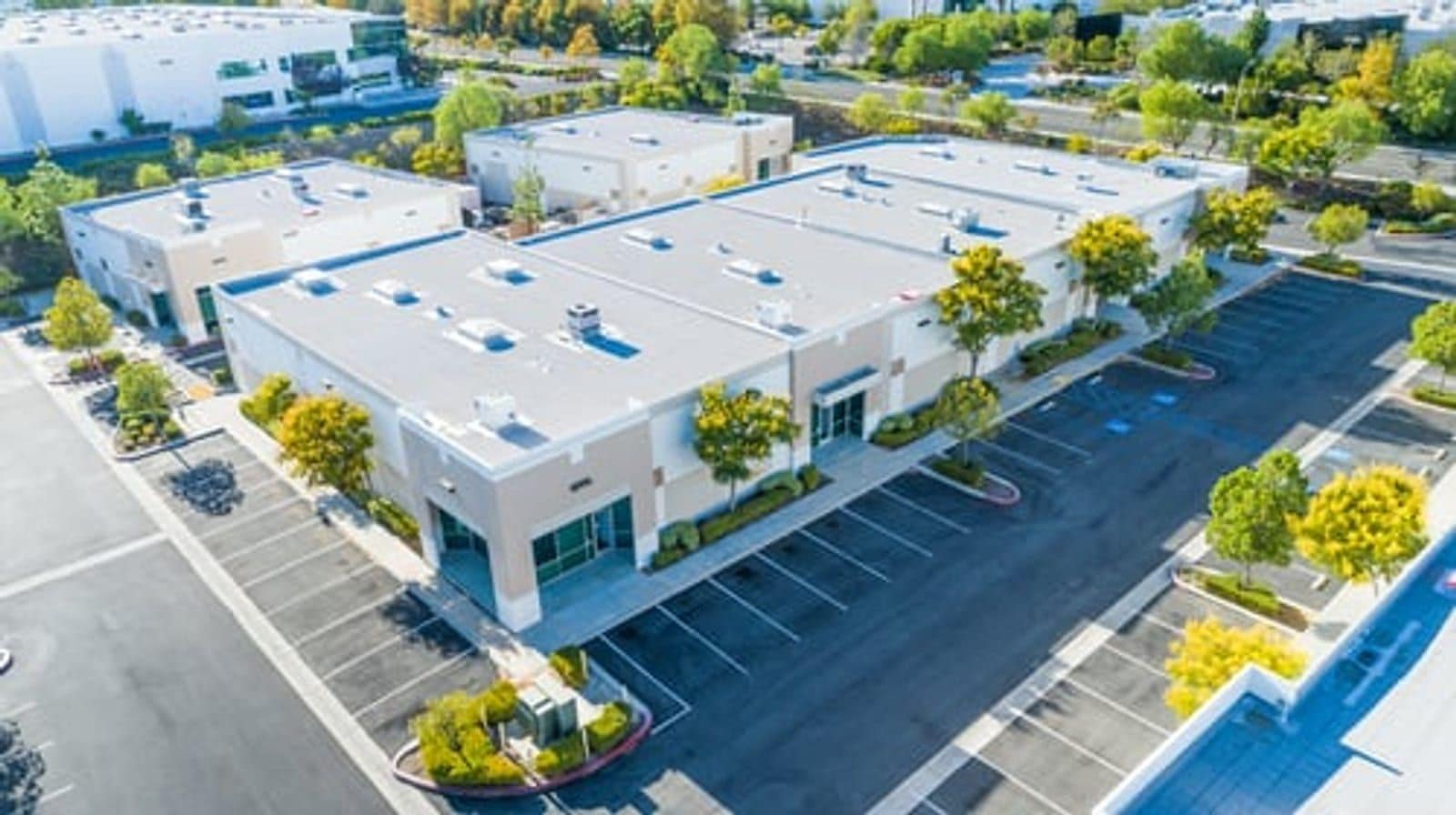 Aerial view of commercial buildings with white flat membrane roofing systems in Wichita, Kansas